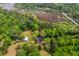 Breathtaking aerial view of a secluded home surrounded by lush trees and serene marshland at 4942 Storage Rd, Meggett, SC 29449