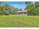 Exterior view of a barn on a spacious green lawn, offering ample storage and rustic charm at 4942 Storage Rd, Meggett, SC 29449