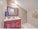 Bathroom with a dark wooden vanity with a white countertop and decorative accents at 4942 Storage Rd, Meggett, SC 29449