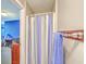 Shower area with blue accents and a privacy curtain at 4942 Storage Rd, Meggett, SC 29449