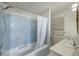 Bright bathroom featuring a combination tub and shower with blue tiling, plus a single sink vanity at 4942 Storage Rd, Meggett, SC 29449