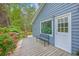 Charming exterior showcasing the entrance with a small deck and vibrant red flower bushes at 4942 Storage Rd, Meggett, SC 29449