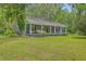 Lovely exterior featuring an inviting porch with a swing and an American flag in the lawn at 4942 Storage Rd, Meggett, SC 29449