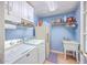 Functional laundry room with washer, dryer, utility sink, and ample cabinet storage at 4942 Storage Rd, Meggett, SC 29449