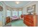 Cozy living room with bay window, decorative sofa, and antique wooden furniture, creating a charming, vintage atmosphere at 4942 Storage Rd, Meggett, SC 29449
