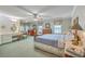 Spacious main bedroom with a sitting area, ceiling fan, and neutral decor at 4942 Storage Rd, Meggett, SC 29449