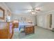 Bright main bedroom with ceiling fan, ample closet space, and hardwood accents at 4942 Storage Rd, Meggett, SC 29449