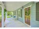 Inviting covered porch featuring a swing, rocking chairs, and stylish decor, perfect for relaxing outdoors at 4942 Storage Rd, Meggett, SC 29449