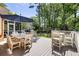Outdoor deck featuring patio seating, a grill, umbrella and a serene wooded backdrop at 501 Willow Branch Way, Mount Pleasant, SC 29464