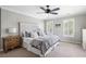 Cozy bedroom with a decorative headboard, ample pillows, and natural light at 501 Willow Branch Way, Mount Pleasant, SC 29464