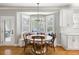 Cozy breakfast nook featuring a bay window, banquette seating, and stylish light fixture at 501 Willow Branch Way, Mount Pleasant, SC 29464