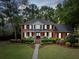 Elegant brick home with classic black shutters and a welcoming front porch at 501 Willow Branch Way, Mount Pleasant, SC 29464