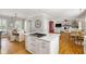 Bright open-concept kitchen showcasing an island with a cooktop and seamless flow into the dining area at 501 Willow Branch Way, Mount Pleasant, SC 29464