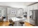 Bright modern kitchen with an island, stainless steel appliances, and stylish white cabinets at 501 Willow Branch Way, Mount Pleasant, SC 29464