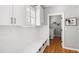 Well-organized mudroom with bench seating, storage cabinets, and a view of the laundry room at 501 Willow Branch Way, Mount Pleasant, SC 29464