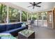 Relaxing screened porch with cozy seating, overlooking the serene backyard and playground at 501 Willow Branch Way, Mount Pleasant, SC 29464