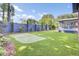 Backyard view features a putting green, privacy fence, and screened-in porch at 5029 Victoria Ave, North Charleston, SC 29405