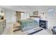 Spacious primary bedroom with a decorative rug, ceiling fan, upholstered headboard and lamps at 5029 Victoria Ave, North Charleston, SC 29405