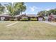 Spacious brick home with a well-manicured lawn, driveway, and a detached garage at 5029 Victoria Ave, North Charleston, SC 29405