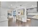 A combined dining and kitchen area with granite counter tops and stainless steel appliances, with hardwood flooring throughout at 5029 Victoria Ave, North Charleston, SC 29405