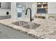 Close up of the kitchen island's granite countertops and modern faucet fixtures at 5029 Victoria Ave, North Charleston, SC 29405