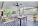 Comfortable screened-in porch with modern fan, dining, and seating areas offers outdoor relaxation at 5029 Victoria Ave, North Charleston, SC 29405