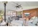 Cozy screened-in porch with brick wall, TV, and comfortable seating for relaxation and entertainment at 5029 Victoria Ave, North Charleston, SC 29405