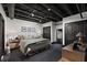 Primary bedroom features black and white carpet, exposed ceilings, and dark trim at 517 King St # 13, Charleston, SC 29403
