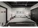 A stylish bedroom features a comfortable bed, modern decor, and unique black-and-white checkered flooring at 517 King St # 13, Charleston, SC 29403
