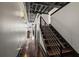 Hallway with wood floors, exposed ceilings, modern lighting and stairs with a metal railing at 517 King St # 13, Charleston, SC 29403