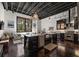 Open concept kitchen features a large island, dark wood floors, black cabinets, and stainless steel appliances at 517 King St # 13, Charleston, SC 29403