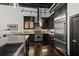 Spacious kitchen boasts stainless steel appliances, black cabinets, a wine cooler, and marble countertops at 517 King St # 13, Charleston, SC 29403