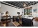 Modern kitchen with black cabinets, stainless steel appliances, a large island and an open layout to the seating area at 517 King St # 13, Charleston, SC 29403