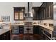 Stylish kitchen featuring dark wood floors, black cabinetry, marble countertops, and stainless steel Viking appliances at 517 King St # 13, Charleston, SC 29403