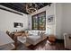 Bright living room with natural light, exposed ceiling, hardwood floors, and modern decor at 517 King St # 13, Charleston, SC 29403