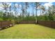 Expansive backyard with lush green lawn and privacy fence, offering plenty of room for outdoor activities at 518 Sound Dr, Summerville, SC 29486
