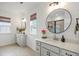 Bright bathroom featuring dual vanities, round mirrors, shiplap accent wall, and glass shower at 518 Sound Dr, Summerville, SC 29486