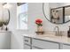 Elegant bathroom featuring bright vanity, round mirror, shiplap walls, and view from the window at 518 Sound Dr, Summerville, SC 29486