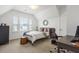 Inviting bedroom featuring sloped ceilings, three windows, comfortable bed, and a desk with chair at 518 Sound Dr, Summerville, SC 29486