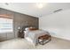 Inviting bedroom with gray paneled accent wall, window view, and comfortable bed with bench at 518 Sound Dr, Summerville, SC 29486