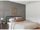 Charming bedroom with gray paneled accent wall, decorative artwork, and comfortable bed with stylish pillows at 518 Sound Dr, Summerville, SC 29486