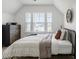 Charming bedroom featuring a comfortable bed, dresser, and three windows with neighborhood views at 518 Sound Dr, Summerville, SC 29486