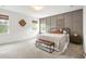 Spacious bedroom with large windows, gray accent wall, and neutral decor for a serene atmosphere at 518 Sound Dr, Summerville, SC 29486