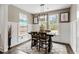 Bright dining room featuring a modern chandelier, backyard views, and wainscoting on the walls at 518 Sound Dr, Summerville, SC 29486