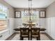 Cozy dining room featuring a modern chandelier, backyard views, and decorative wainscoting at 518 Sound Dr, Summerville, SC 29486