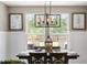 Light-filled dining room featuring a modern chandelier, backyard views, and attractive wall decor at 518 Sound Dr, Summerville, SC 29486