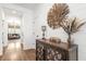 Elegant entryway featuring hardwood floors, a decorative mirror, and a stylish wooden cabinet at 518 Sound Dr, Summerville, SC 29486