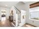 Bright entryway with hardwood floors, white walls, coat hooks, and a wooden cabinet at 518 Sound Dr, Summerville, SC 29486