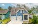 Charming blue two-story home with white trim, two-car garage, and landscaped front yard at 518 Sound Dr, Summerville, SC 29486