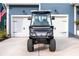 Front view of a custom golf cart parked in front of a home with garage doors at 518 Sound Dr, Summerville, SC 29486